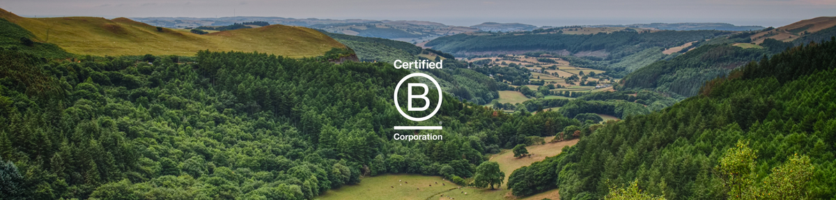 Certified B Corporation logo over a forested green valley